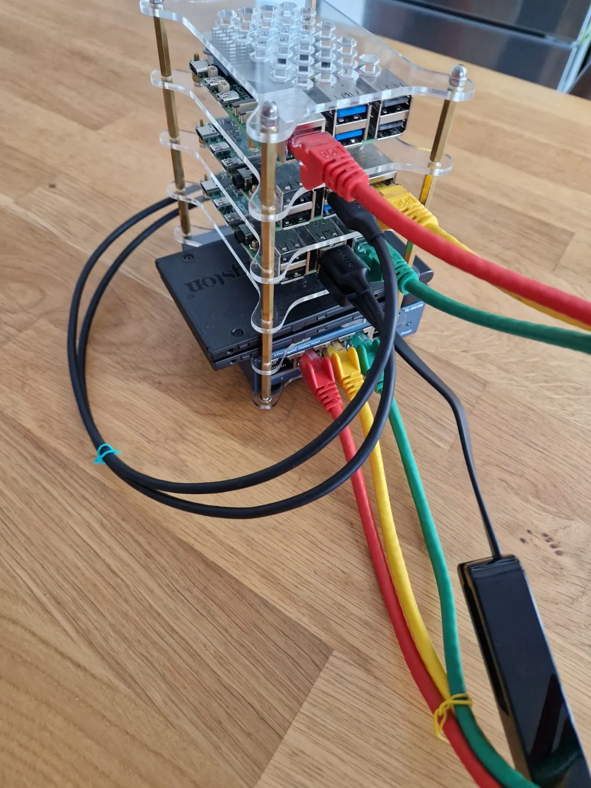 Raspberry Pi cluster, fully connected with colored cables and UE306 for internet. Power supplies are not visible.